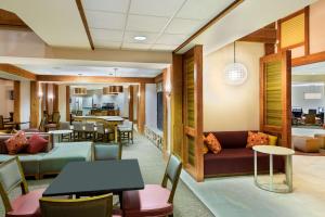 a lobby of a hotel with tables and chairs at Homewood Suites by Hilton Raleigh/Crabtree Valley in Raleigh
