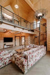 a large living room with couches and a tv at Chata za wsią - Czorsztyn Lake, Kluszkowce Ski in Kluszkowce