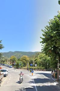 a person riding a motorcycle down a street at GELSOMINO in Levanto +2 photos