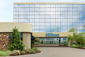 a building with a hilton sign in front of it at Hilton Kansas City Airport in Kansas City