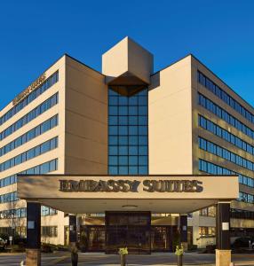 a large building with a sign in front of it at Embassy Suites Tysons Corner in Tysons Corner