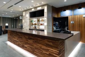 a bar in a hotel with a large counter at Courtyard Charlotte Steele Creek in Charlotte