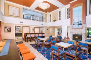 a restaurant with tables and chairs and a fireplace at Hampton Inn & Suites Annapolis in Annapolis