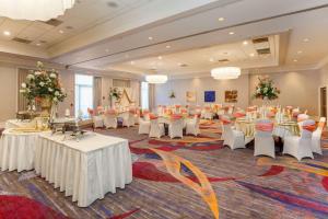 a banquet hall with white tables and white chairs at DoubleTree by Hilton Atlanta Airport in Atlanta