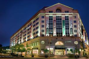 a large building with lights on it at night at Embassy Suites by Hilton Washington DC Chevy Chase Pavilion in Washington