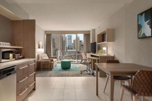 a kitchen and living room with a view of a city at Home2 Suites By Hilton Chicago River North in Chicago