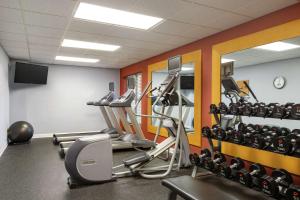 a gym with several tread machines and a mirror at Homewood Suites by Hilton St. Petersburg Clearwater in Clearwater