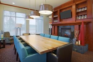 a dining room with a wooden table and blue chairs at Hilton Garden Inn Austin North in Austin
