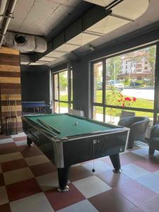 a room with a pool table in a room at Arboro Borovets Gardens E43 in Borovets