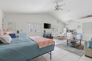 a bedroom with a bed and a living room at The Splash Pad Sleeps 13 w Pool Patio and Garage in Panama City