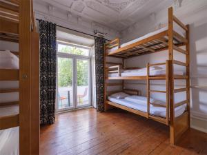 a room with two bunk beds and a window at Lisbon Chillout Hostel in Lisbon
