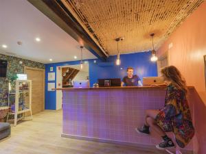 a man and a woman sitting at a bar at Lisbon Chillout Hostel in Lisbon