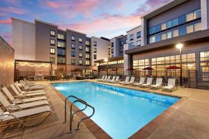 a pool at a hotel with lounge chairs at Homewood Suites By Hilton Long Beach Airport in Long Beach