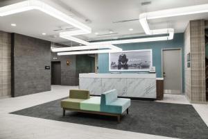 a lobby with a chair and a reception desk at Hampton Inn & Suites Miami Wynwood Design District, FL in Miami