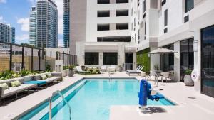 a swimming pool on the roof of a building at Hampton Inn & Suites Miami Wynwood Design District, FL in Miami