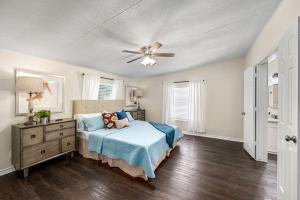 a bedroom with a bed and a ceiling fan at Conroe TX Handicap Accessible Home Pets Welcome in Conroe