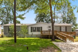 a home with a large deck and trees at Conroe TX Handicap Accessible Home Pets Welcome in Conroe