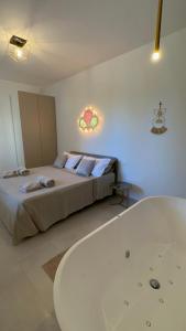 a bedroom with a bed and a bath tub at Il Gelsomino luxury suites in Bari