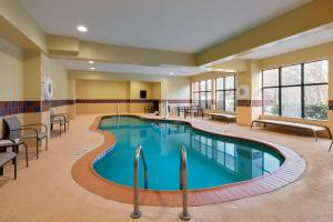 a pool in a hotel room with chairs and a table at Hampton Inn & Suites Providence / Smithfield in Smithfield