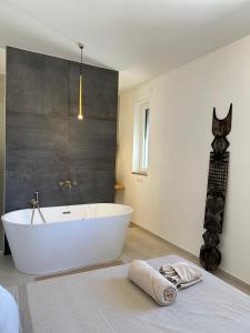 a bathroom with a white tub in a room at Il Gelsomino luxury suites in Bari