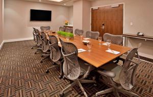 a conference room with a large wooden table and chairs at Hilton Garden Inn New York Central Park South-Midtown West in New York