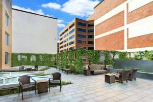 a patio with tables and chairs in front of a building at Hilton Garden Inn Washington DC/Georgetown Area in Washington