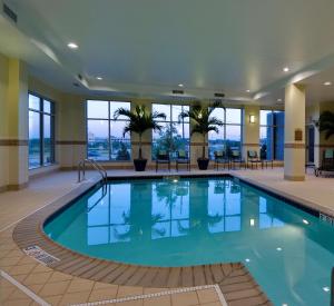 a pool in a hotel lobby with windows at Hilton Garden Inn Lake Forest Mettawa in Lake Forest