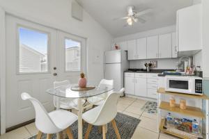 a kitchen with a table and chairs and a microwave at Luxe Pool Casita w Saltwater Pool 25 Min to PCB in Panama City