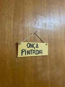 a sign that reads onega philadelphia hanging on a wall at Em Busca Hostel in Bonito