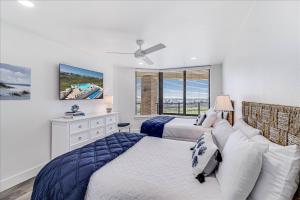 a bedroom with two beds and a window at 8th Floor Penthouse Luxury Beautifully Remodeled in Port Aransas