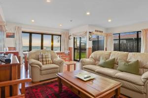 a living room with a couch and a coffee table at Taupo Beachfront Escape 12min to Town - Free Wifi in Waitahanui