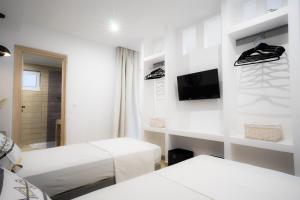 a hospital room with two beds and a tv at Mousikorama Apartments in Faliraki