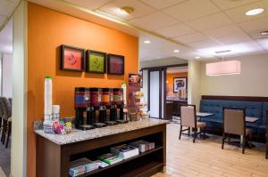 a waiting room with a counter with bottles of wine at Hampton Inn Danville in Danville