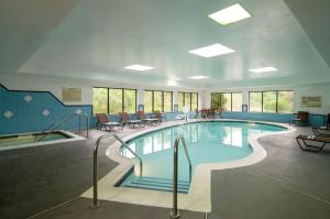 a large swimming pool in a building with tables and chairs at Hampton Inn Danville in Danville