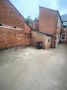 an empty parking lot next to a brick building at Luxury Fully Furnished Bedroom in Leicester