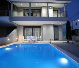 a swimming pool in front of a house at Heaven Horizon Villa - Ethereal and Blissful Gem in Karianí
