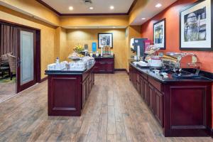 a large room with a counter with food on it at Hampton Inn & Suites Austin South Buda in Buda