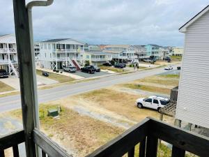 a view from a balcony of a street with houses at Serenitee in Holden Beach