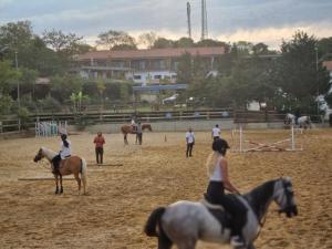a group of people riding horses in a field at MAVİ AT HOTEL Blue Horse in Gümüşdere