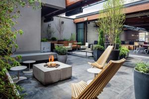 an outdoor patio with chairs and a fire pit at Freepoint Hotel Cambridge, Tapestry Collection by Hilton in Cambridge