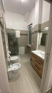 a bathroom with two sinks and a toilet and a shower at Residenza Belvedere in Termoli