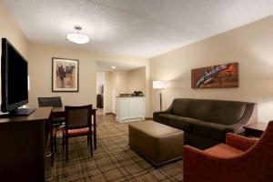 a living room with a couch and a table at Embassy Suites Cleveland - Beachwood in Beachwood