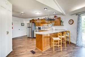 a kitchen with wooden cabinets and a counter top at Guntersville Hideaway with Mountain and Lake Views! in Albertville