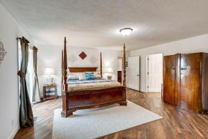 a bedroom with a bed with a wooden frame at Guntersville Hideaway with Mountain and Lake Views! in Albertville