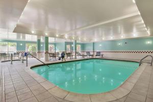 uma piscina num quarto grande com mesas e cadeiras em Homewood Suites by Hilton Dallas-DFW Airport N-Grapevine em Grapevine