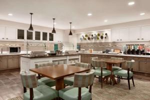 a kitchen with a table and chairs in a kitchen at Homewood Suites by Hilton Columbus-Dublin in Dublin