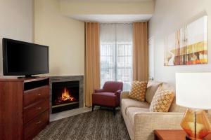 a living room with a couch and a fireplace at Homewood Suites by Hilton Dallas-DFW Airport N-Grapevine in Grapevine
