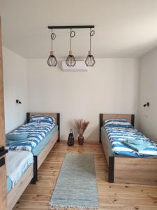 Katil atau katil-katil dalam bilik di Apartamenty Grodzisko