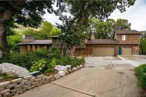 a brick house with a driveway and a garage at Upper Mountain Haus Studio Close to Slopes Mtns in Ogden