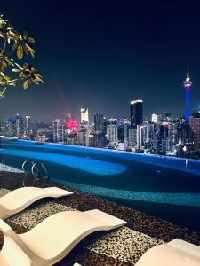 a swimming pool with a view of a city skyline at Axon Serviced Suites Kuala Lumpur in Kuala Lumpur